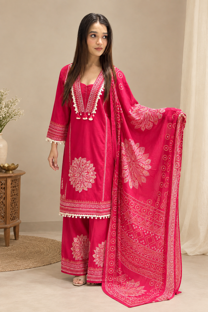 Model wearing a fuchsia floral kurta set with printed dupatta