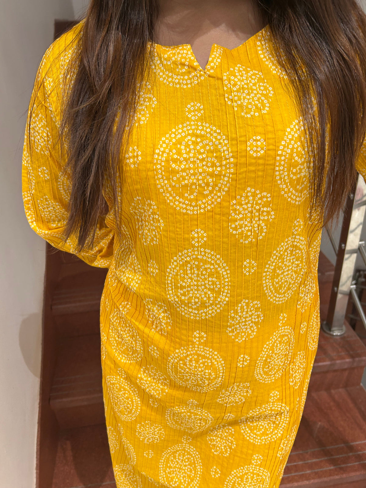 Model wearing yellow bandhani print cotton kurti full length